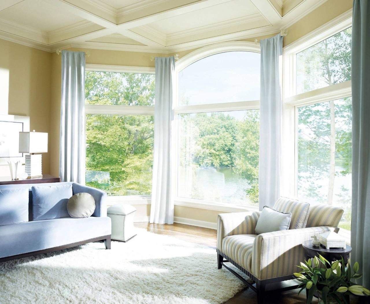 Living room with an arched window dressed with Hunter Douglas Silhouette® Sheer Shades at Window Accents & Flooring near Princeton, NJ